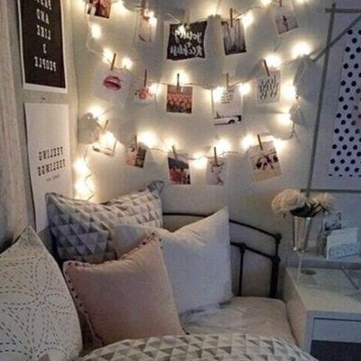 Photo of hanging twinkle lights with photos, making a pretty shabby chic bedroom